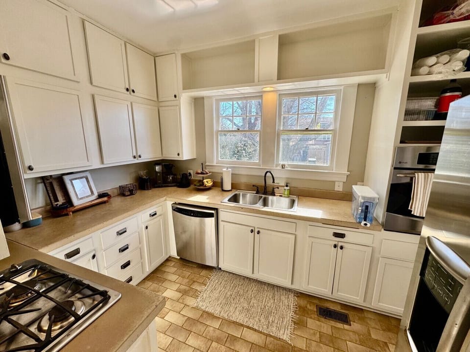 Full kitchen with comfortable sitting area and access to dining room as well as back patio.