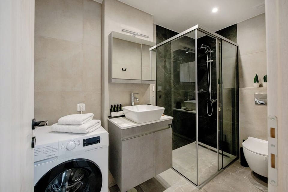 A refined space with elegant fixtures and a spacious vanity for luxury guests.