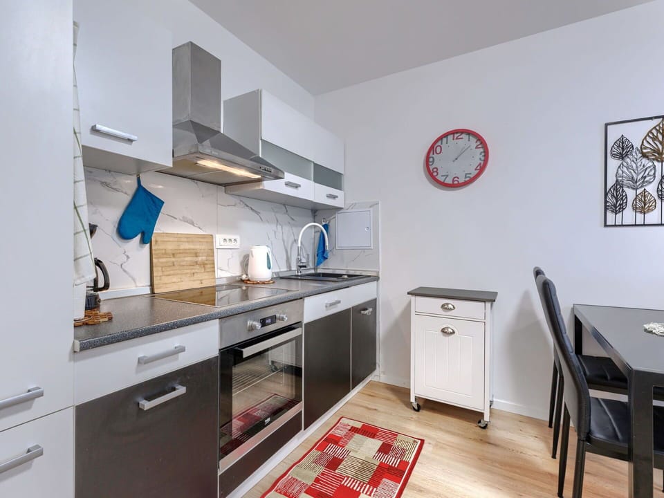Furniture, Interior Design, Flooring, Cabinetry, Floor, Room, Kitchen, Major Appliance, Countertop, Kitchen Appliance