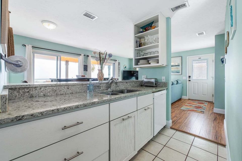 The kitchen is a functional and inviting space, equipped with all the essential appliances to make meal preparation a breeze.