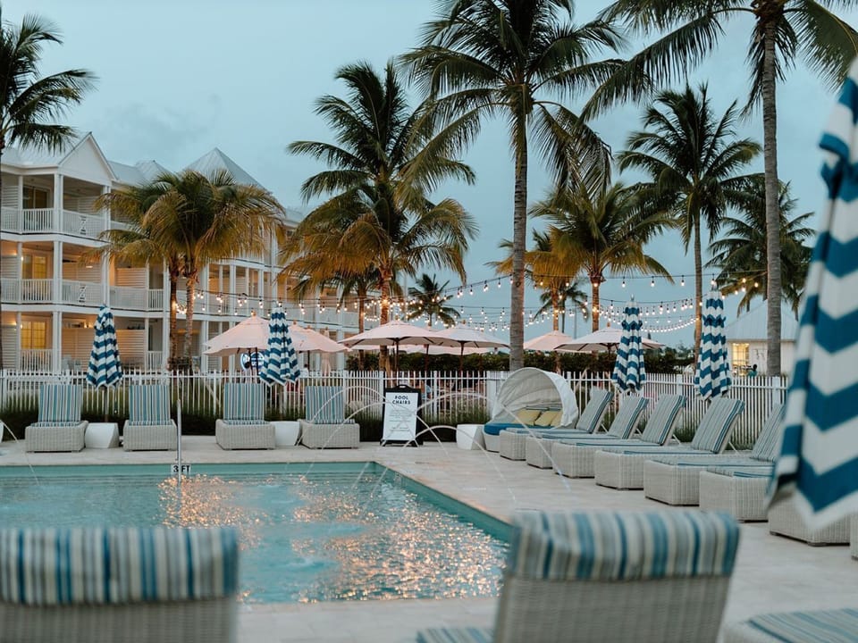 Cozy seating by the poolside invites you to relax amidst swaying palms and evening ambiance.