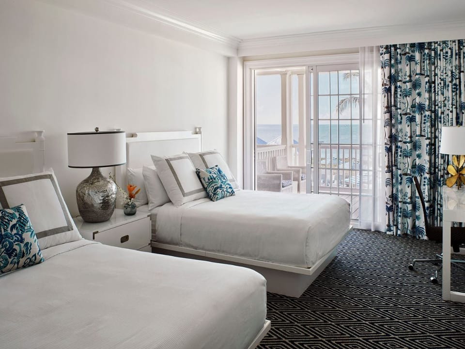 Bright and airy bedroom with soft accents and large windows overlooking serene views.