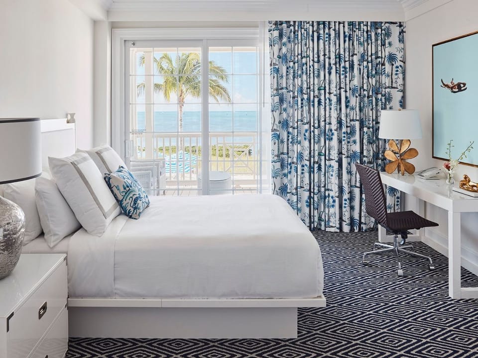 Light and airy bedroom with a plush bed and oceanfront views, ideal for peaceful mornings.