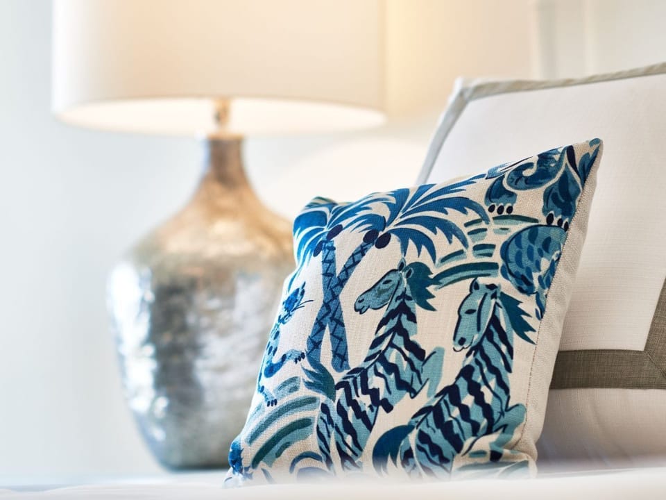 Decorative pillow with vibrant patterns adds a charming and cozy touch to the elegant decor.
