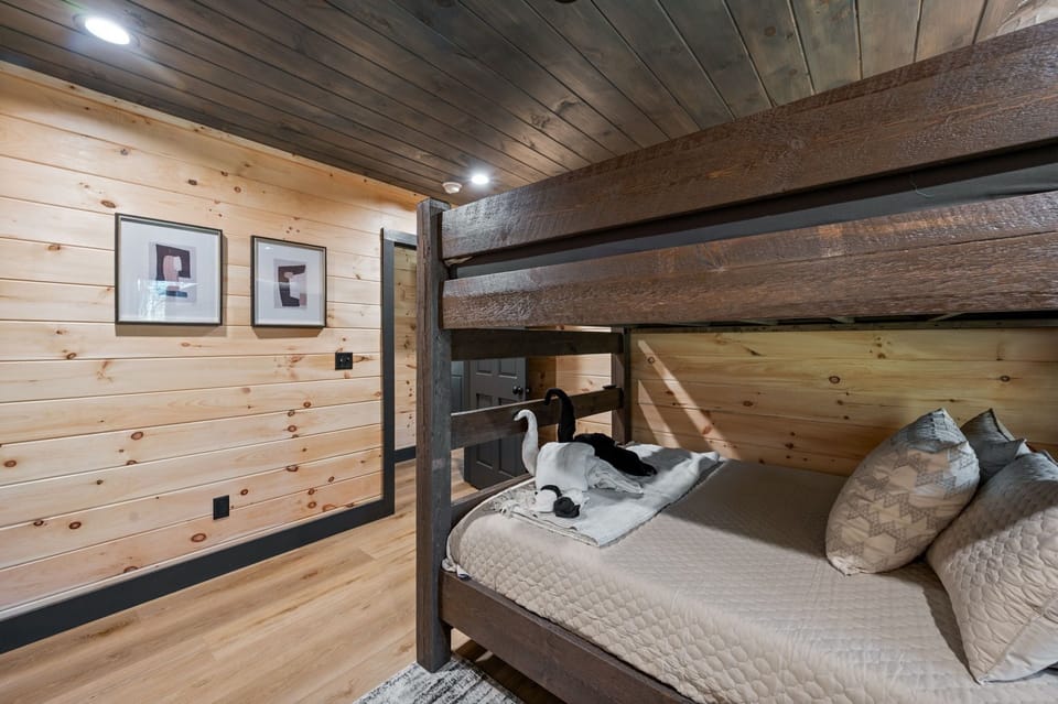 Queen bunk beds with en suite bathroom and TV.