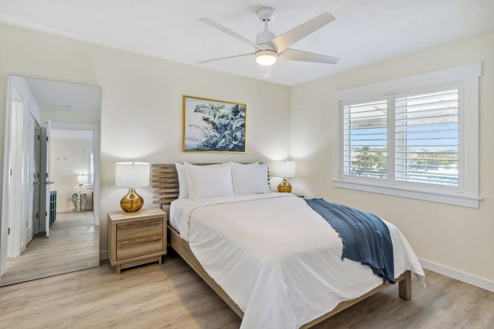 Unwind in airy comfort with crisp linens and coastal light.