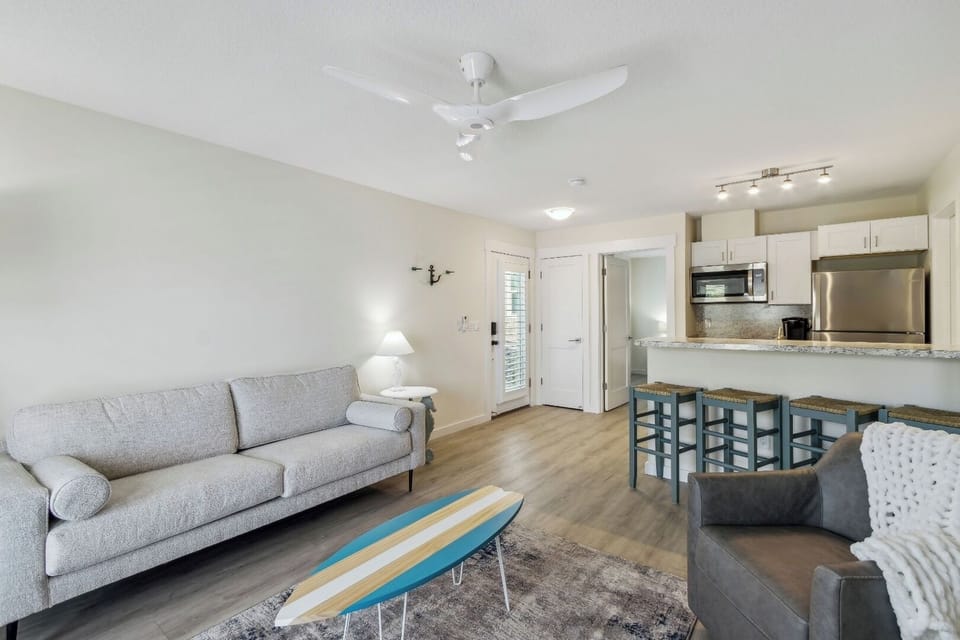 Gather in the airy living space with easy kitchen access.