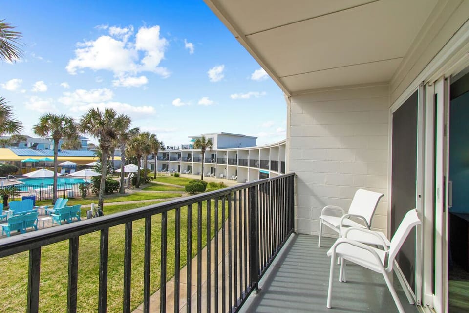 Sip morning coffee on the balcony overlooking resort grounds.