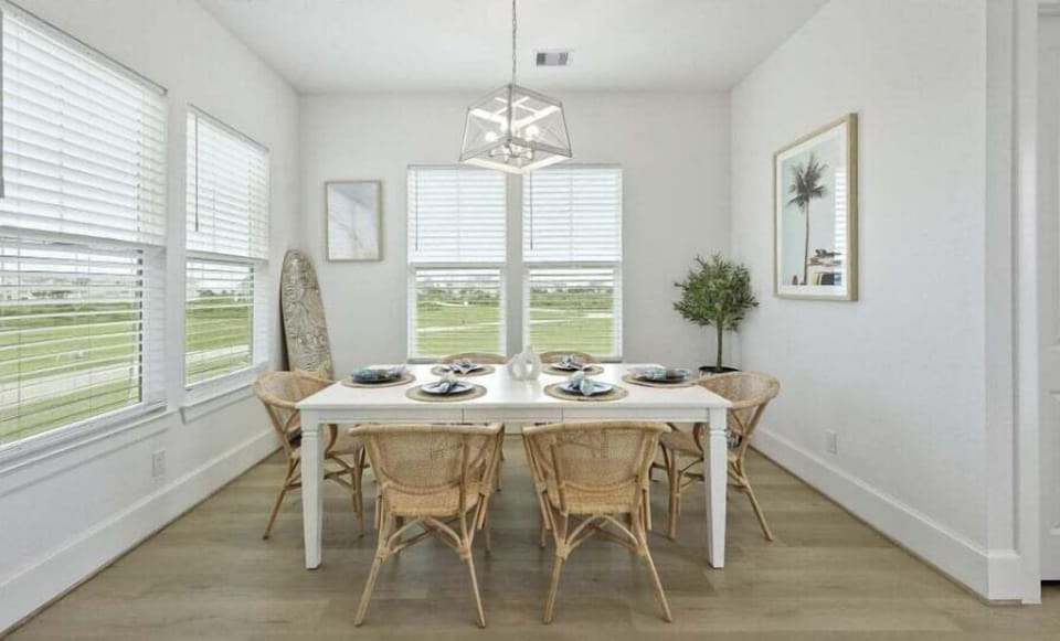Dining room with large windows and scenic views—bright and inviting space for gatherings.