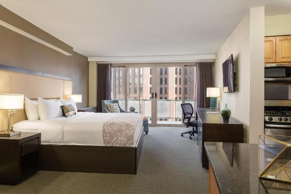 Enjoy extra space with a work desk and in-room kitchen.