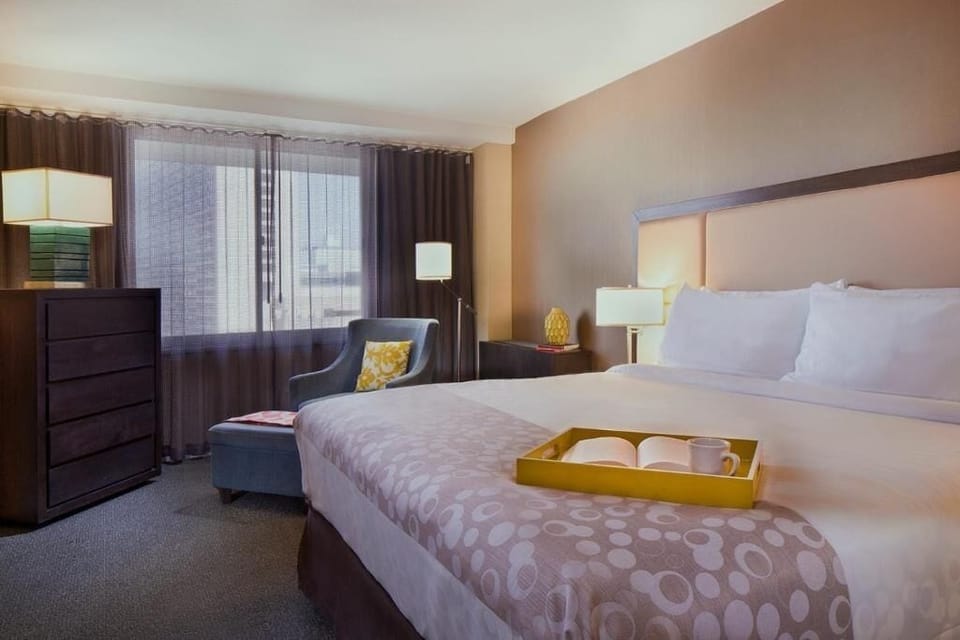 Sip morning coffee beside a cozy chair and king bed.