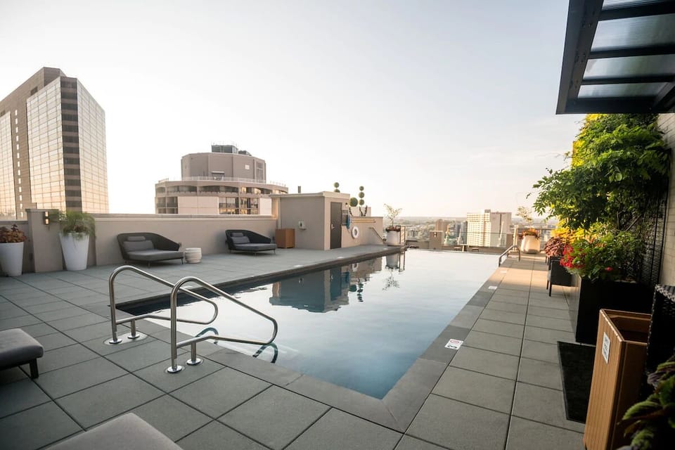 Dive into serene rooftop laps as the skyline stretches wide.