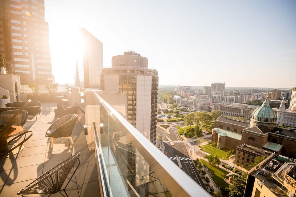 Soak in golden-hour city views from the airy balcony.