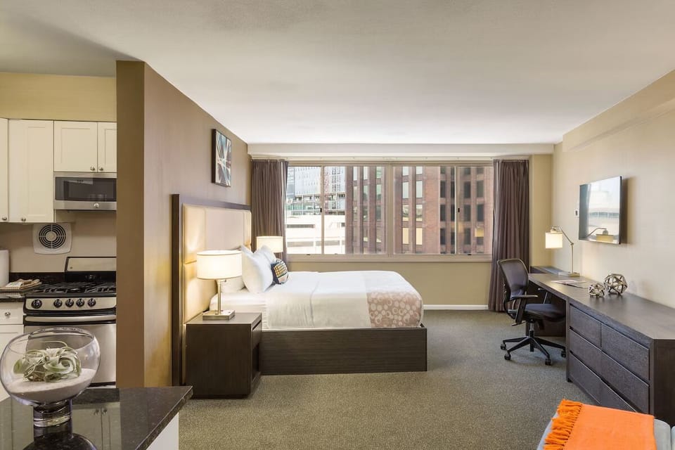 Recharge in a calm bedroom with dedicated work desk.