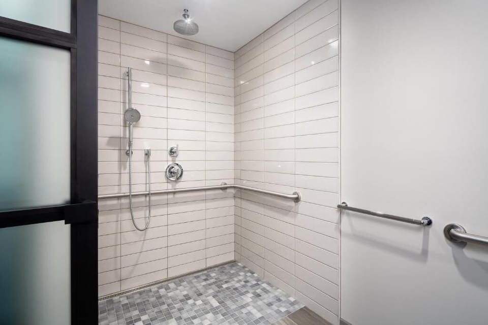 Enjoy an easy, accessible shower with clean modern tile.