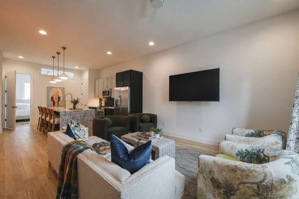 Open-concept living room and kitchen with modern decor.