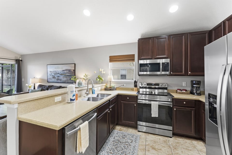 Bright modern kitchen featuring stainless steel appliances and ample counter space