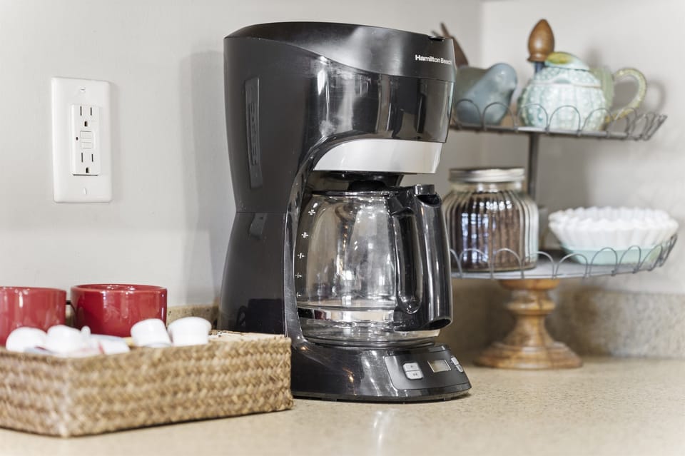 Coffee station with a drip coffee maker and mugs ready for your morning brew