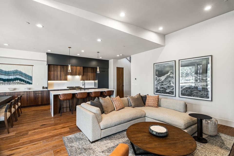 Relax in the inviting great room, where soaring ceilings and large windows flood the space with natural light while framing the picturesque mountain scenery. Cozy up by the fireplace and enjoy the Smart TV.