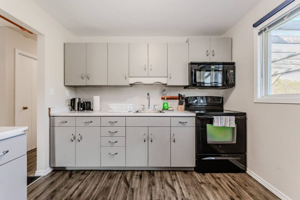 Functionality meets style in the kitchen, featuring ample cabinet space and modern appliances, with easy access to the deck for when dining al fresco calls.