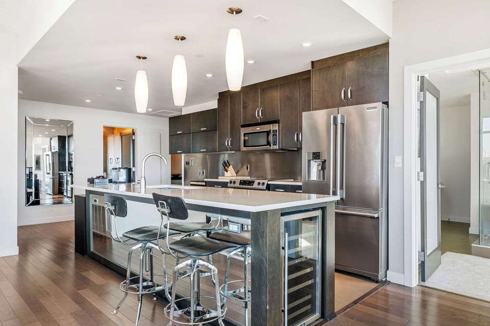 A high-end kitchen featuring premium appliances, sleek countertops, and sophisticated finishes, perfect for culinary enthusiasts.