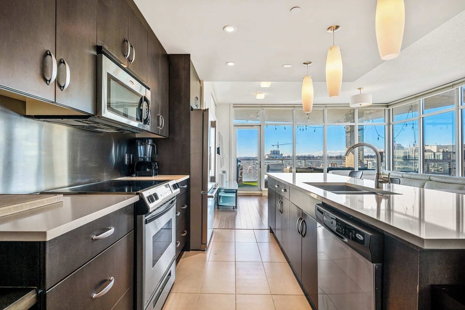 the expansive open floor plan blends the kitchen, dining room, and living room, offering a bright, welcoming atmosphere throughout.