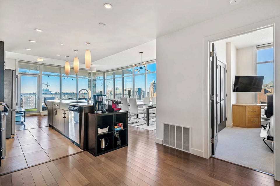A spacious, open-concept layout combining the kitchen, dining room, and living room