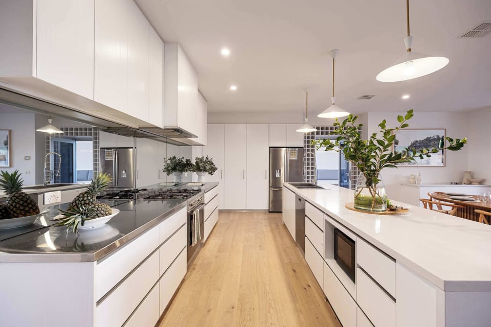Chef's Dream Kitchen I  Step into a spacious kitchen designed for culinary creativity and social gatherings. Featuring expansive countertops and modern appliances, this kitchen offers ample room for meal prep and entertaining. 