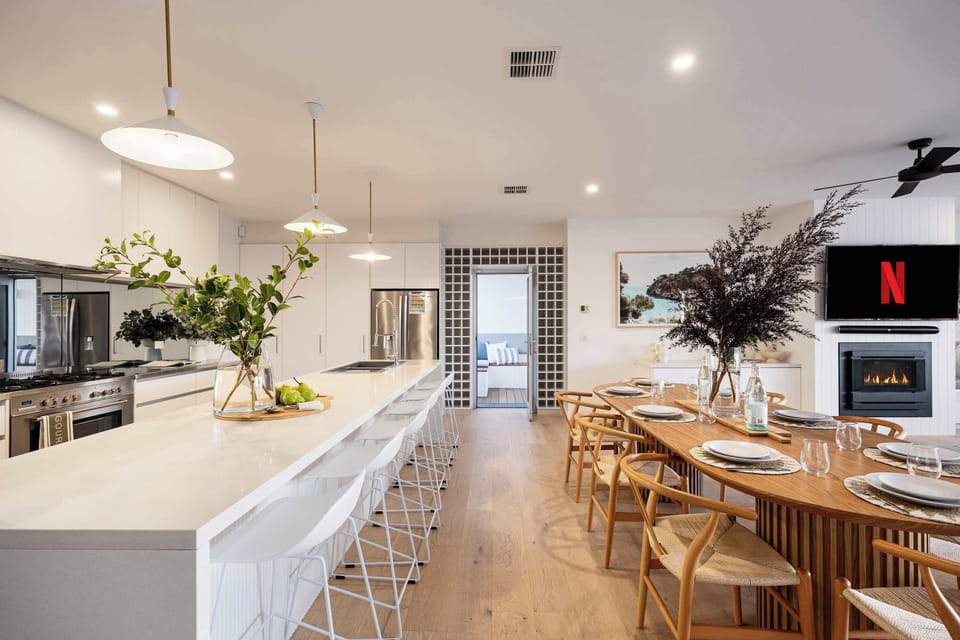 Spacious Dining Oasis I Create unforgettable memories in our expansive breakfast nook featuring two beautifully designed tables, perfect for large gatherings. This inviting space accommodates family breakfasts and lively dinners.