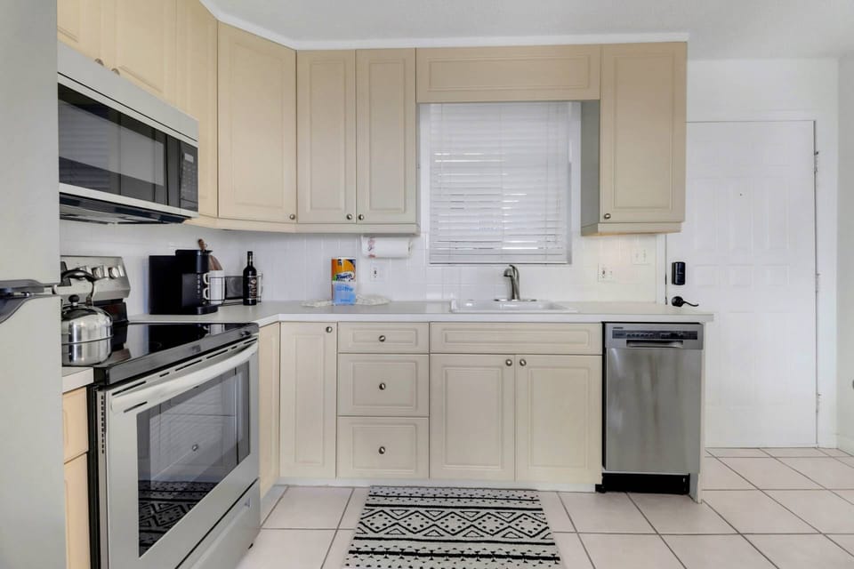 Cookware, dinnerware, many kitchen tools and small appliances are provided, including a Keurig-style coffee maker.