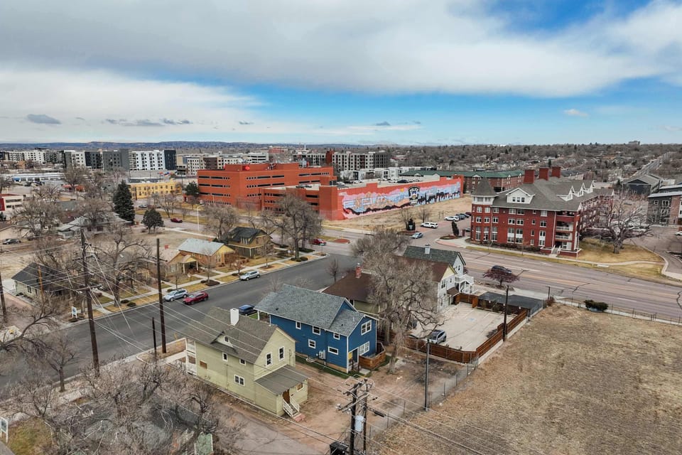 An aerial view highlighting the property's prime location, with easy access to downtown, local attractions, and major roads. Each unit is rented separately for a private stay.
