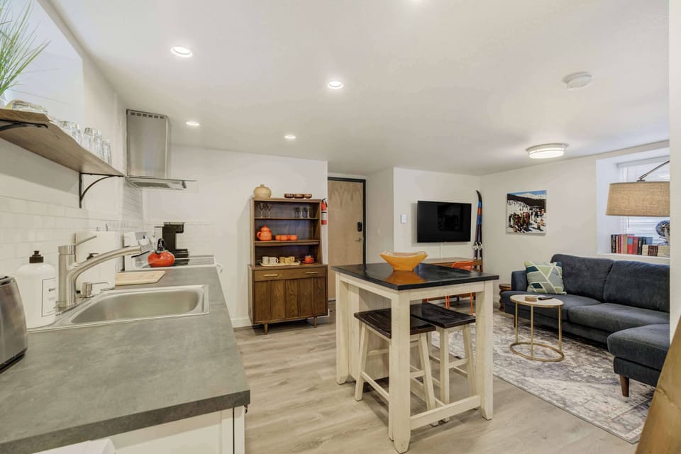 Open-concept layout featuring a modern kitchen, cozy dining area, and inviting living space with a Smart TV for entertainment.





