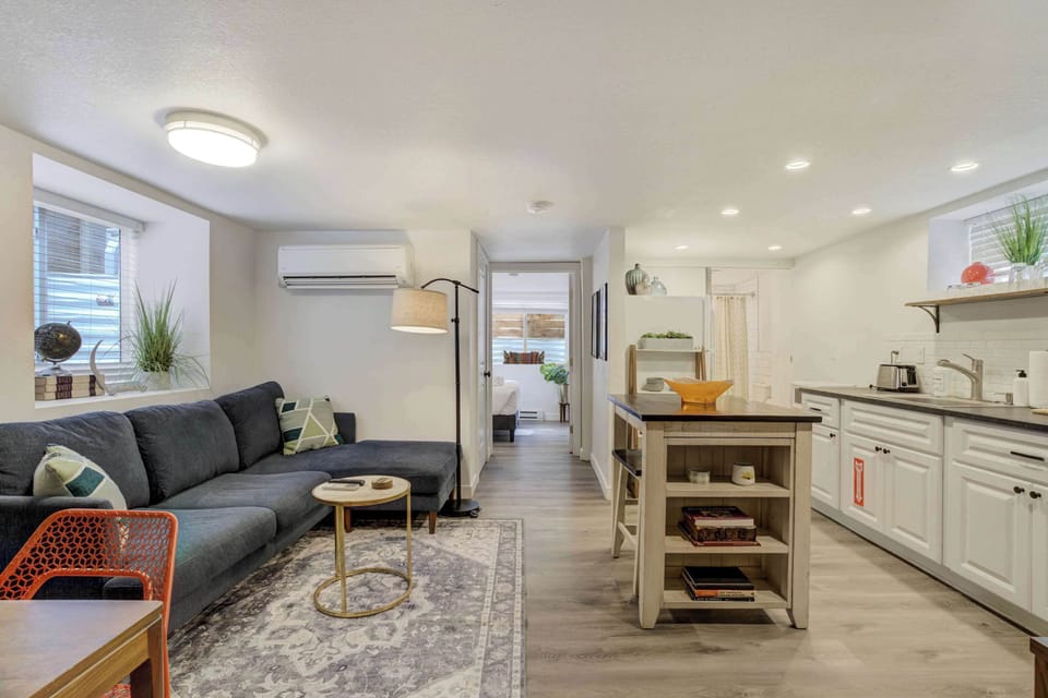 Bright and inviting open-concept space featuring a modern kitchen, cozy living area, and seamless flow into the bedroom for a comfortable stay.





