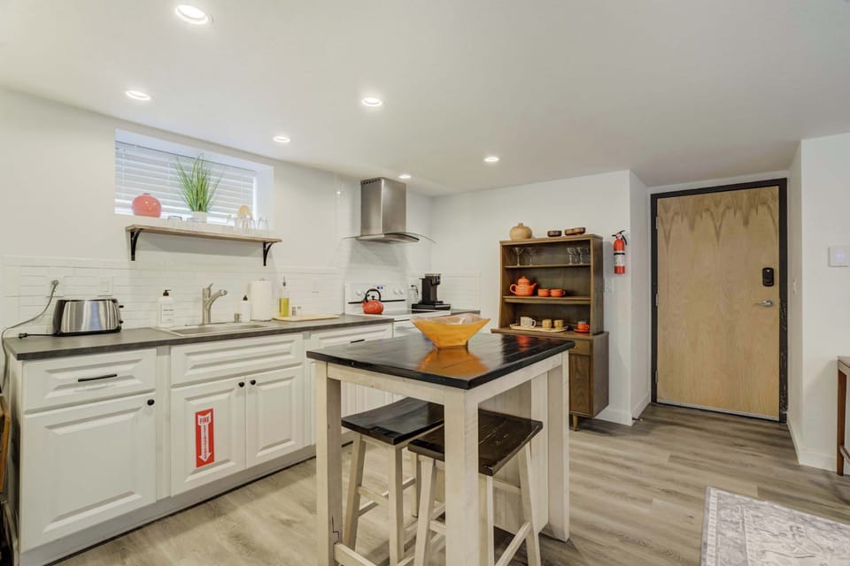 Bright and modern kitchen with stainless steel appliances, ample counter space, and a cozy dining area for enjoying home-cooked meals.






