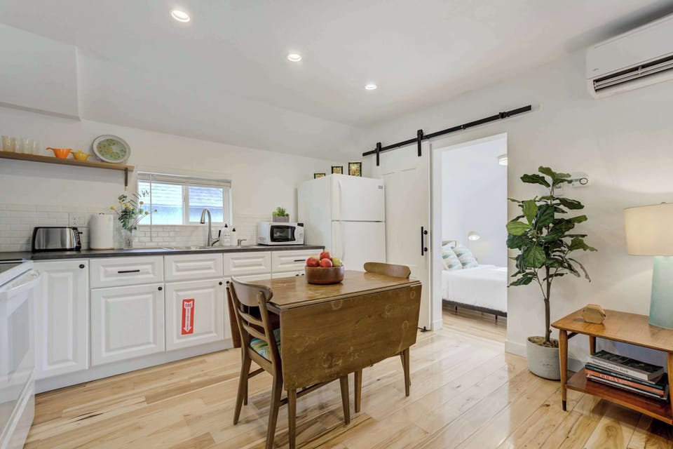 A fully equipped kitchen with modern appliances, ample counter space, and a cozy dining area perfect for meals or remote work.






