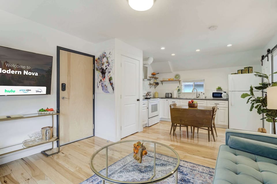 Bright and airy living space with a stylish open layout, Smart TV, and comfortable seating, perfect for unwinding.
