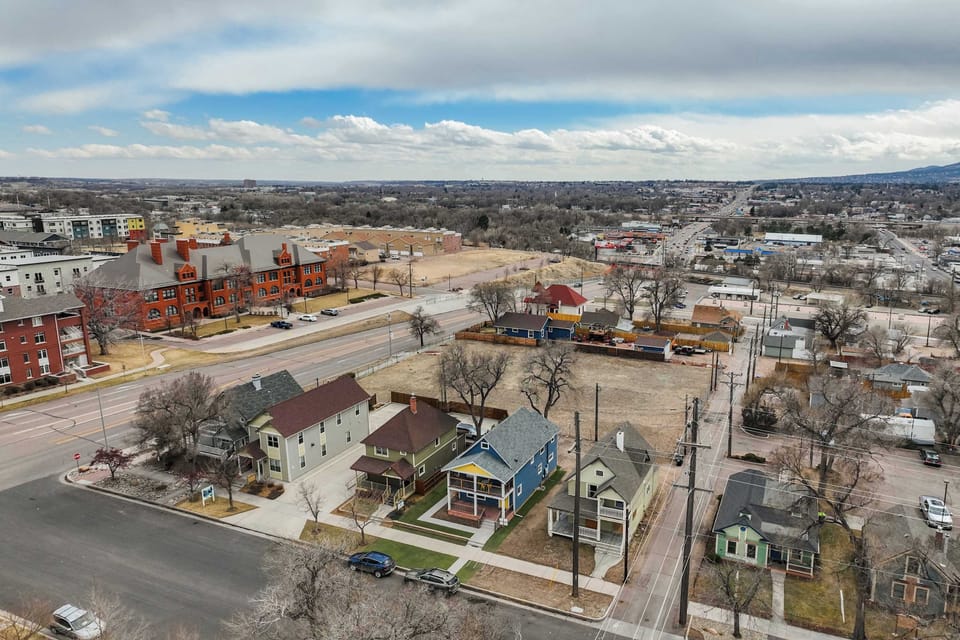 An aerial view highlighting the property's prime location, with easy access to downtown, local attractions, and major roads. Each unit is rented separately for a private stay.
