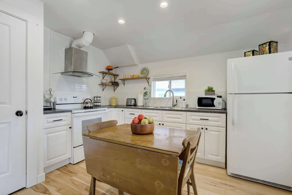 Fully equipped kitchen with modern appliances, ample counter space, and a cozy dining area—perfect for enjoying home-cooked meals.





