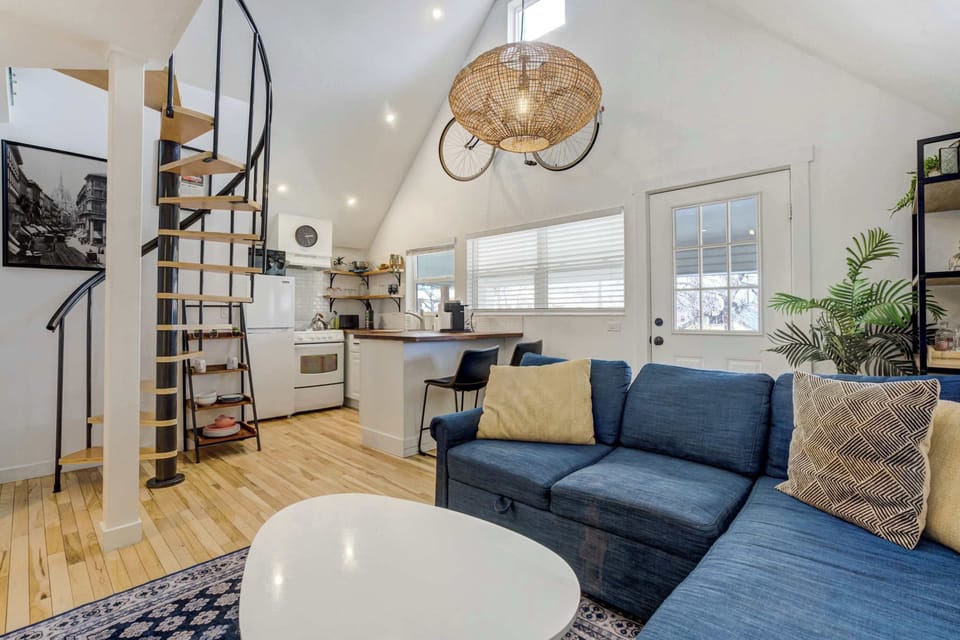 This stunning upstairs loft boasts vaulted ceilings, a stylish spiral staircase, and an inviting open-concept layout designed for comfort and relaxation.





