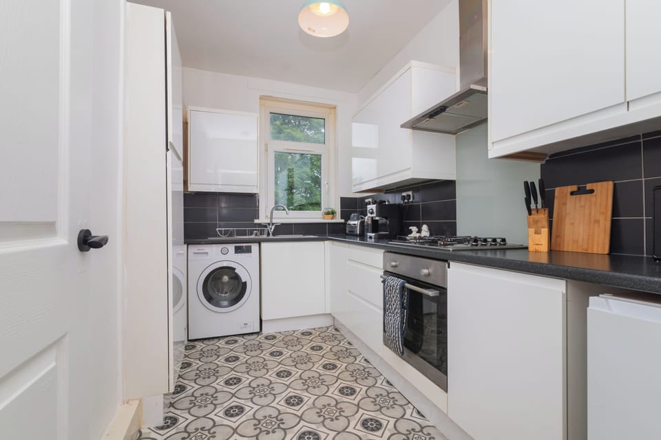 A stylish, fully equipped kitchen that combines practicality with a warm, welcoming atmosphere for all.