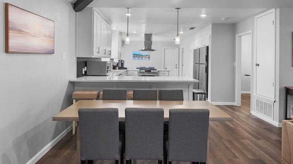 Welcome to a beautifully designed kitchen featuring modern cabinetry and a spacious dining table, perfect for sharing meals and creating memories. Enjoy the sleek countertops and impeccable finishes that make this apartment a true gem.