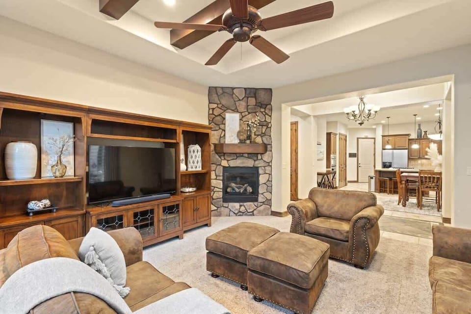 Living room with TV, fireplace, and plenty of comfortable seatin