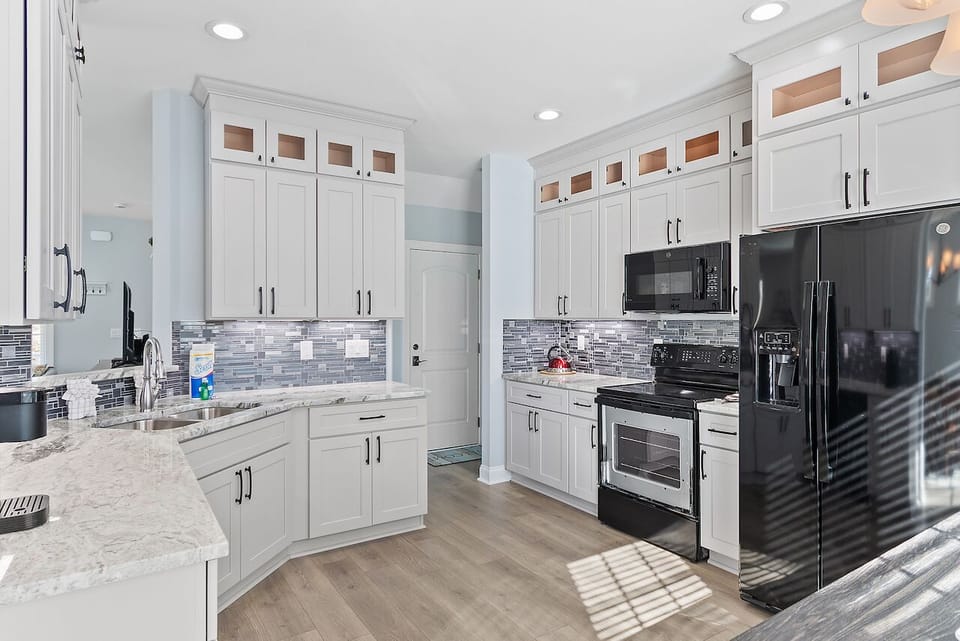 Prepare your favorite meals in this stunning modern kitchen with granite countertops, stainless steel appliances, and ample cabinet storage for all your culinary adventures.