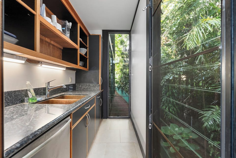 Sleek modern kitchenette with scenic views, perfect for quick meals or refreshments.