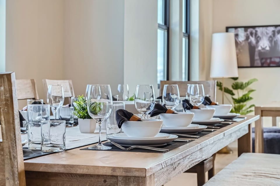 Enjoy meals in this bright, farmhouse-style dining area. The spacious wooden table and versatile bench seating provide the perfect setting for family gatherings or entertaining guests.