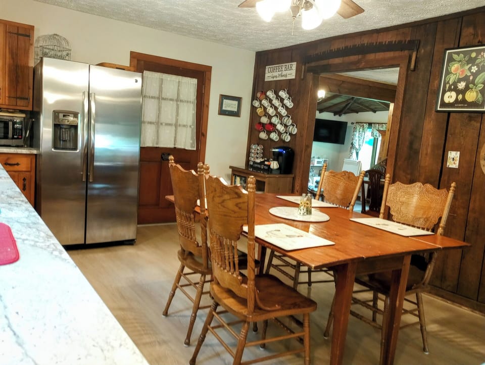 View of kitchen through dining room to sitting room. Additional chairs available