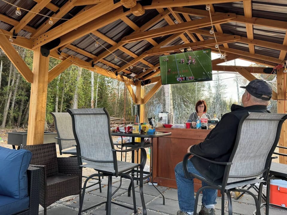 Outdoor covered bar area provides a place to watch a game, make a drink, eat, and relax. 