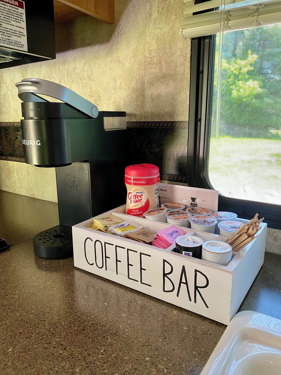 Keurig, gas stove, oven, sink, fridge and kitchen complete with the essentials.