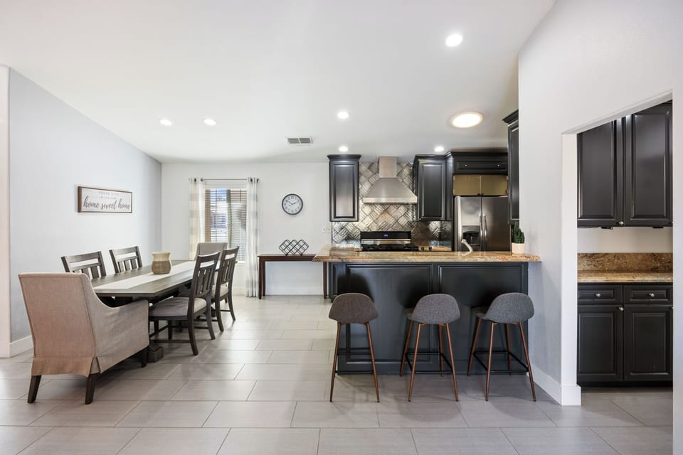 Kitchen island with bar seating and granite countertops.