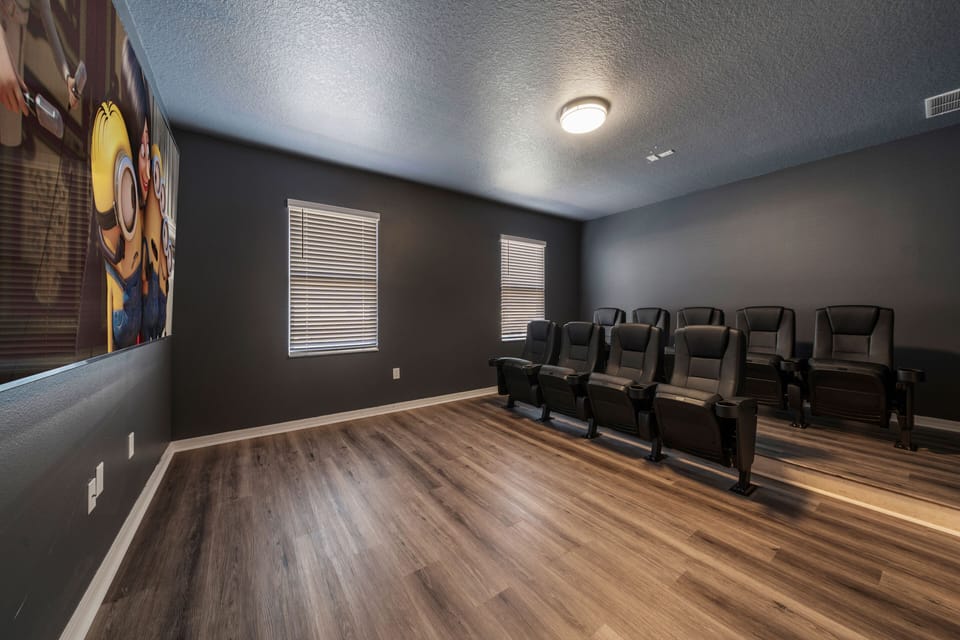 - Private home theater with reclining cinema style seating  
- Dark cozy walls and big screen for immersive family movies  
- Orlando vacation rental with in-home theater experience